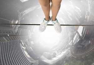 Top view of person standing on rope above city